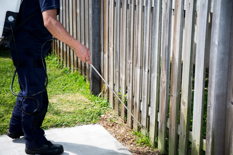 DeBugem technician treating a Greenacres home for ghost ants